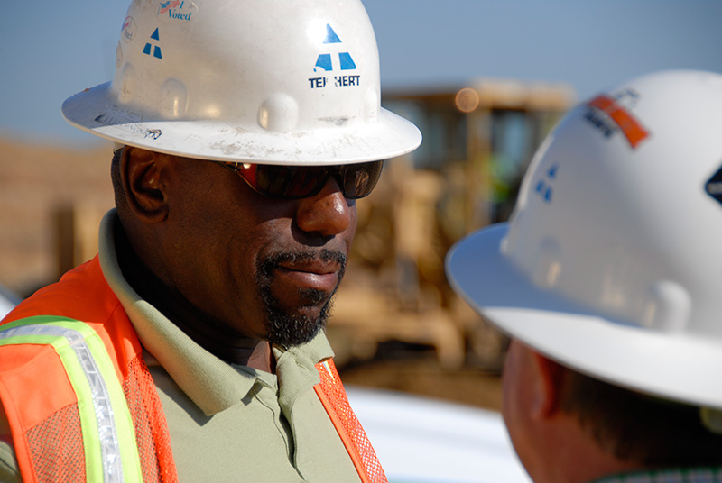 an image of two ̳ employees talking at a job site