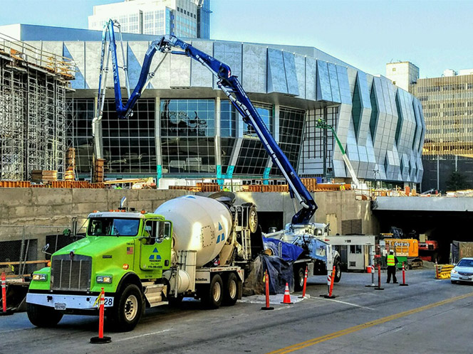 a landscape photo of a green Teichert cement truck pouring cement at the site of the new Golden One Sacramento Kings Arena